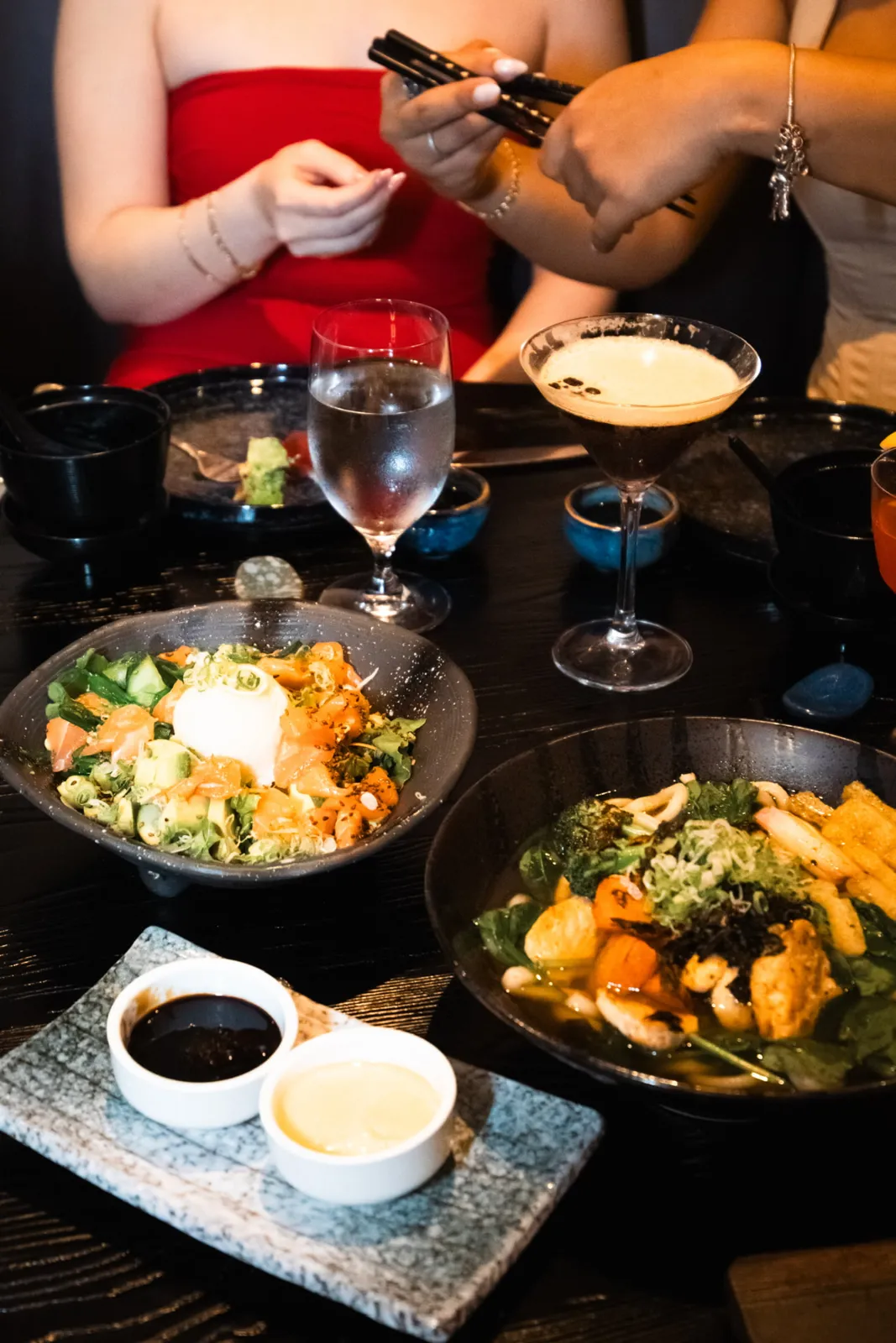 Poke bowl, udon and an espresso martini on the table
