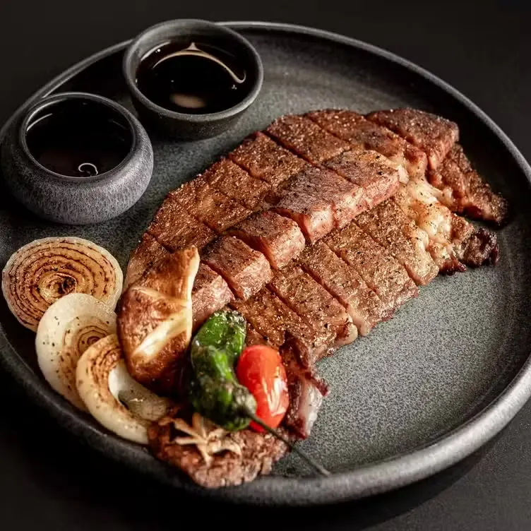 Sliced wagyu steak with charred onion and dipping sauces