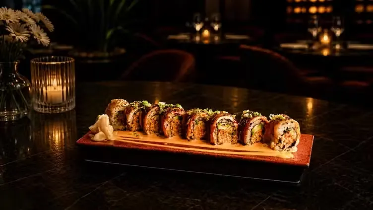 A signature roll served on a warm wooden board by candlelight