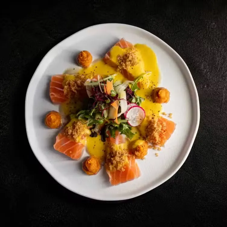 Salmon carpaccio with citrus sauce and micro herbs